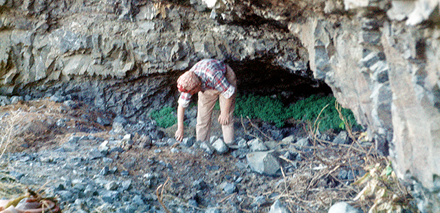 45KT48. Kay Nelson examines debris on the floor of the rockshelter.